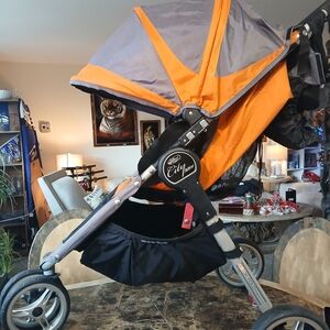 The Baby Jogger City Mini Stroller in Orange and Black is a high-quality, versat